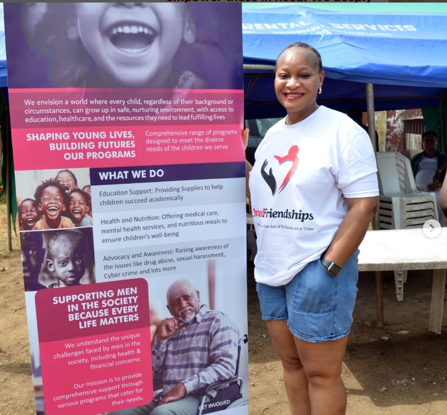 United Friendships volunteers standing beside a community programme display